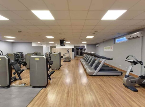 Intérieur spacieux d'une salle de fitness moderne avec divers équipements.
